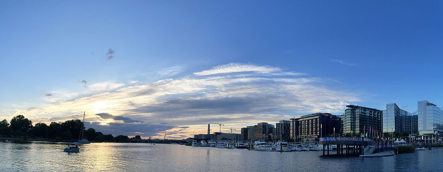 Panoramic Photo of Waterway With Big Late Afternoon Sky and Washington Monument in Background.